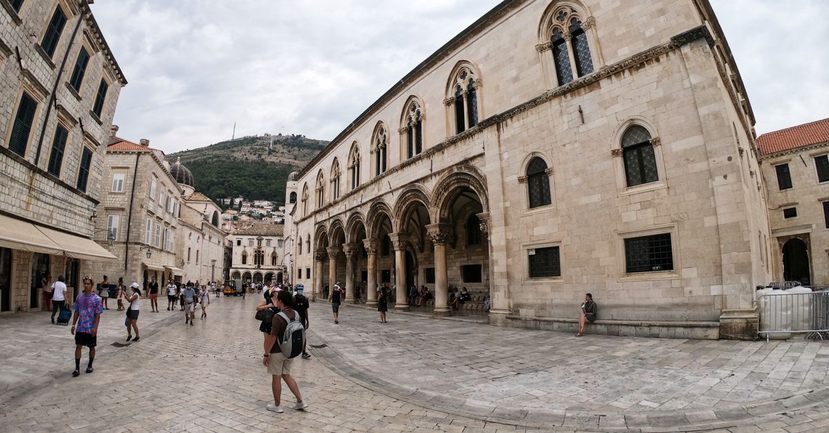 People walking through the historic stone streets of Dubrovnik's Old Town