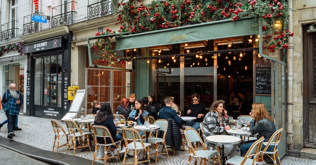 Lively Parisian cafe terrace with people dining outdoors